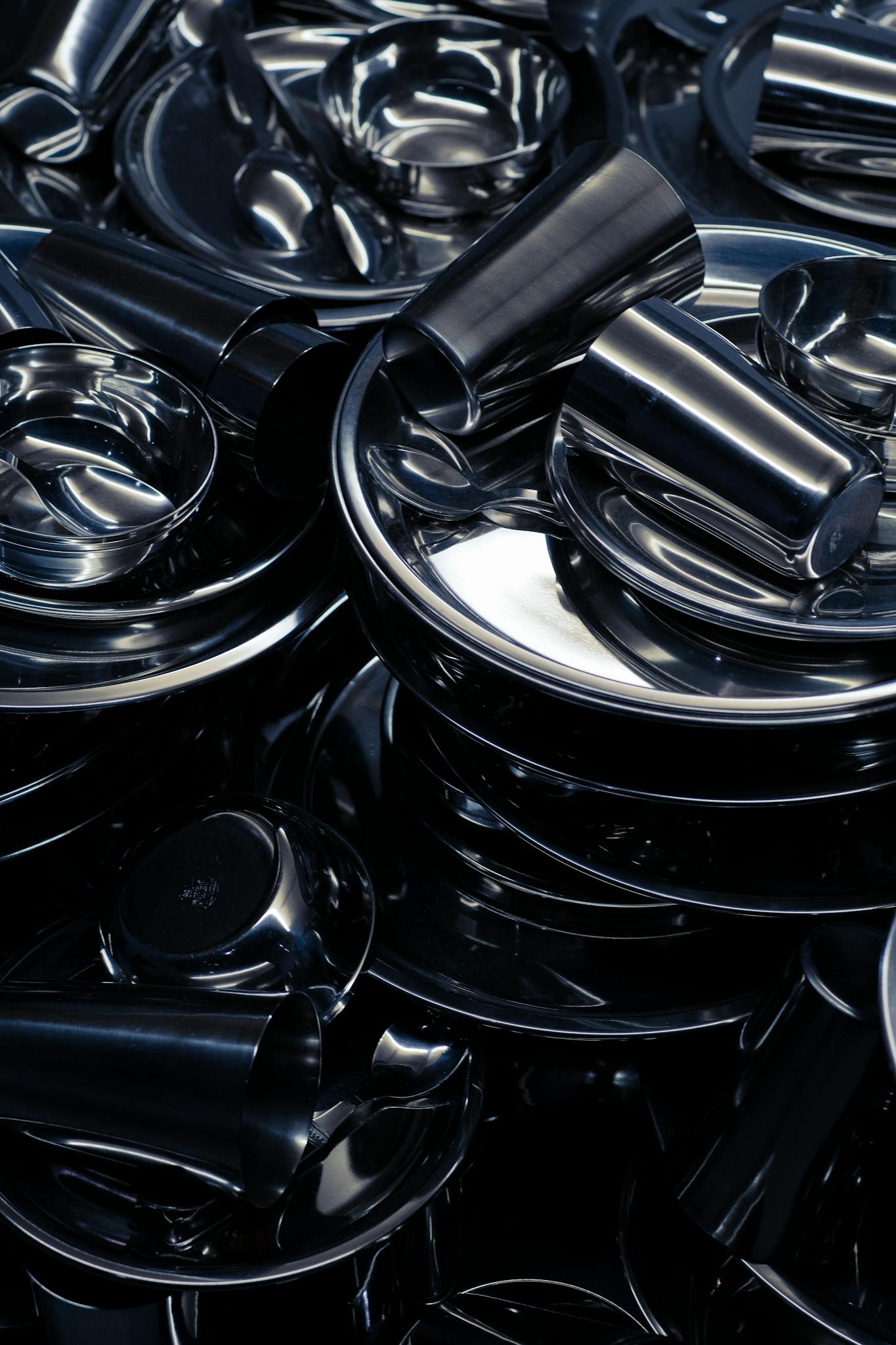 Abstract arrangement of metallic parts with shiny chrome reflections in a vertical shot.